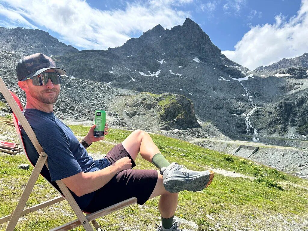 Ian relaxing in a deckchair with mountain and glacier views